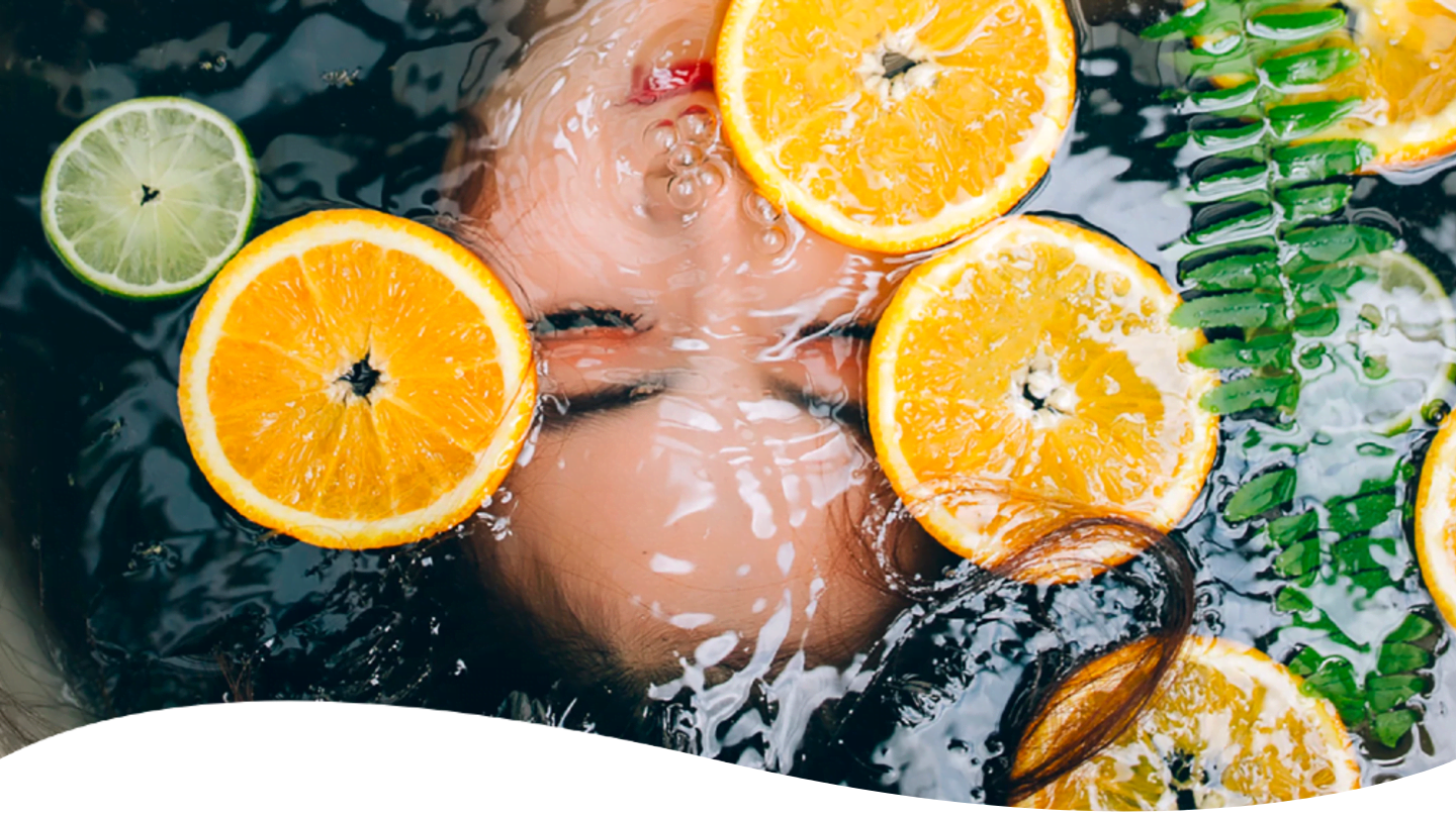 woman under water with citrus fruits